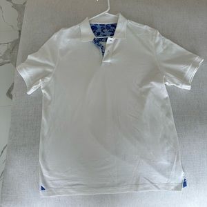 White UNTUCKit polo with blue floral detail